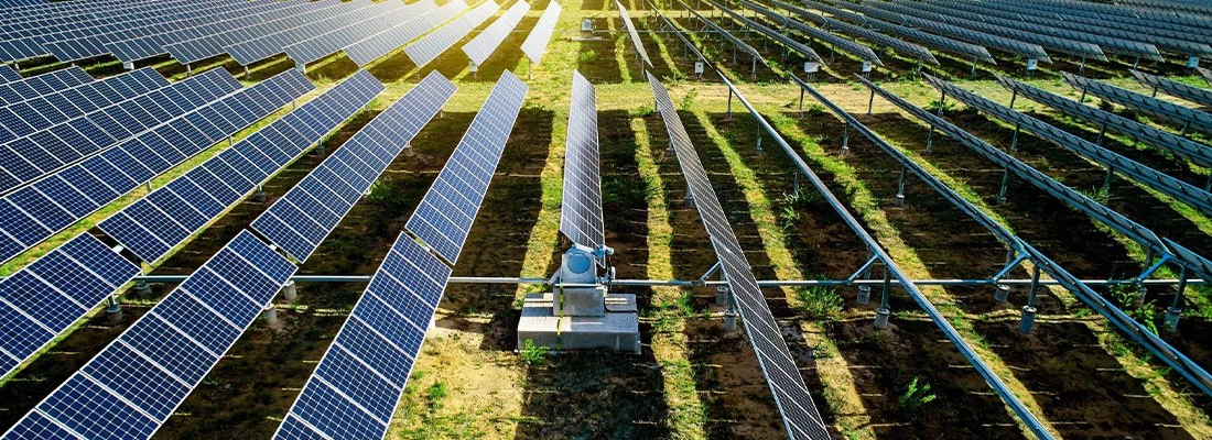 ## Exploring the Power of the Sun: The Operations and Advantages of Solar Energy Systems In a world increasingly calling for sustainable and eco-friendly energy sources, solar energy systems stand out as a significant renewable energy solution, becoming a key player in the energy sector. Solar power systems capture the energy from the sun, transforming it into electricity, thereby offering vast potential and advantages for both our society and our environment. ## Understanding Solar Energy Systems A solar power system, also referred to as a photovoltaic system, is a configuration designed to utilize the photovoltaic effect to transform sunlight into electrical energy. It comprises solar panels (photovoltaic panels), a battery storage system, and an inverter. Solar power systems are prolific in residential, commercial, and industrial spheres, as well as in remote and off-grid locations. They present a green, renewable power solution that can decrease the dependency on traditional fossil fuels while minimizing pollution. The progression of solar power systems also profits from technological advancements and governmental incentives for renewable energy, gradually becoming a crucial aspect of the global energy conversion. ## Elements of a Solar Energy System A solar power system is a setup that converts sunlight into electrical energy. It primarily consists of the following components: **Solar Panels:** These are the essential element of a solar power system, made up of numerous photovoltaic cells. As sunlight hits these cells, the semiconductor material within the cells generates a photoelectric effect, transforming light energy into direct current (DC) electricity. **Mounting and Securing Equipment**: Solar panels need to be positioned on brackets or fixed appliances to face the sun and maintain an optimal tilt angle for maximum sunlight absorption. **Inverter**: The electricity generated by solar panels is DC, but most domestic and commercial applications require alternating current (AC) power. An inverter changes DC into AC to feed the grid or for local consumption. **Battery Energy Storage System (optional):** At times, a solar power system includes a battery storage system to stock electricity generated during the day for utilization during the night or on overcast days. The storage system can consist of lead-acid batteries, lithium-ion batteries, or other types of batteries. **Charge Controller (optional)**: If the solar power system is utilized to charge batteries, a charge controller will oversee the battery status and manage the charging process to ensure charging efficiency and safety. **Grid Connection (optional)**: For grid-connected solar power systems, grid connection equipment such as a grid inverter and power metering devices are necessary. These devices enable the system to feed surplus electricity into the grid or draw electricity from the grid to make up for deficiencies. **Power Monitoring System**: Solar power systems usually include a power monitoring system to observe and record data such as electricity generation, power output, battery status, etc. The monitoring system can be accessed through a display screen, mobile app, or remote cloud platform. ## Operating Principle of a Solar Energy System The working principle of a solar energy system is based on the photovoltaic effect, a physical phenomenon that converts solar energy into electrical energy. When sunlight hits a photovoltaic cell, photon energy is absorbed by photovoltaic material (usually silicon), causing the electrons in the material to get enough energy to transition to the conduction band, forming electron-hole pairs. This process creates a voltage difference, forming an electric field at both ends of the cell. When an external circuit is connected to the photovoltaic cell, electrons will flow along the circuit, forming a current. This DC can be converted into AC by an inverter, for grid supply or direct use. The realization of the photovoltaic effect depends on the structure and material characteristics of photovoltaic cells. Generally, a photovoltaic cell is composed of multiple wafers or stacked photovoltaic materials, each material layer has optimal absorption characteristics for a specific wavelength of light. This structure ensures that the photovoltaic cell can efficiently absorb solar energy across different spectral ranges. Other components in the solar power system, such as brackets, inverters, battery energy storage systems, and grid connection devices, are designed to optimize the efficiency and reliability of solar power generation. Brackets are used to install and position solar panels to receive maximum solar radiation. The inverter converts the DC produced by the photovoltaic cells into AC to meet power needs or connect to the grid. The battery storage system can store excess electricity for use at night or under low light conditions. Grid connection devices connect the solar power system to the grid, enabling two-way power flow and energy interaction. Through the operating principle of the solar power system, light energy is efficiently converted into electrical energy, providing a clean, renewable energy solution. This sustainable form of energy is widely used globally and is expected to play an increasingly important role in future energy systems. ## Advantages of Solar Energy Systems As a clean energy solution, solar power systems have numerous advantages, such as: **Environmental Protection and Sustainability**: Solar power systems generate electricity from sunlight, a renewable and plentiful energy source, without emitting harmful pollutants. This makes them a green and sustainable energy solution. **Reduced Energy Costs:** By generating electricity locally, solar power systems can helpusers lower their electricity expenses. In some regions, surplus electricity can even be sold back to the grid, providing an additional source of income. **Energy Independence**: Utilizing a solar power system enables users to generate their own electricity, lessening reliance on the grid and improving energy security. **Versatility**: Solar power systems can be installed in a wide variety of settings, from rooftops to open fields, and can be scaled to meet different energy requirements. **Low Maintenance**: Once set up, solar power systems need minimal maintenance, making them a convenient and cost-effective energy solution. ## Conclusion As a clean, sustainable, and increasingly economical energy source, solar power, captured through solar power systems, offers numerous benefits. This includes not only aiding the environment but also providing a source of renewable energy that reduces our reliance on fossil fuels. As our understanding and technology continue to evolve, solar power systems will play an increasingly significant role in the global energy landscape. ## Exploring the Power of the Sun: The Operations and Advantages of Solar Energy Systems In a world increasingly calling for sustainable and eco-friendly energy sources, solar energy systems stand out as a significant renewable energy solution, becoming a key player in the energy sector. Solar power systems capture the energy from the sun, transforming it into electricity, thereby offering vast potential and advantages for both our society and our environment. ## Understanding Solar Energy Systems A solar power system, also referred to as a photovoltaic system, is a configuration designed to utilize the photovoltaic effect to transform sunlight into electrical energy. It comprises solar panels (photovoltaic panels), a battery storage system, and an inverter. Solar power systems are prolific in residential, commercial, and industrial spheres, as well as in remote and off-grid locations. They present a green, renewable power solution that can decrease the dependency on traditional fossil fuels while minimizing pollution. The progression of solar power systems also profits from technological advancements and governmental incentives for renewable energy, gradually becoming a crucial aspect of the global energy conversion. ## Elements of a Solar Energy System A solar power system is a setup that converts sunlight into electrical energy. It primarily consists of the following components: **Solar Panels:** These are the essential element of a solar power system, made up of numerous photovoltaic cells. As sunlight hits these cells, the semiconductor material within the cells generates a photoelectric effect, transforming light energy into direct current (DC) electricity. **Mounting and Securing Equipment**: Solar panels need to be positioned on brackets or fixed appliances to face the sun and maintain an optimal tilt angle for maximum sunlight absorption. **Inverter**: The electricity generated by solar panels is DC, but most domestic and commercial applications require alternating current (AC) power. An inverter changes DC into AC to feed the grid or for local consumption. **Battery Energy Storage System (optional):** At times, a solar power system includes a battery storage system to stock electricity generated during the day for utilization during the night or on overcast days. The storage system can consist of lead-acid batteries, lithium-ion batteries, or other types of batteries. **Charge Controller (optional)**: If the solar power system is utilized to charge batteries, a charge controller will oversee the battery status and manage the charging process to ensure charging efficiency and safety. **Grid Connection (optional)**: For grid-connected solar power systems, grid connection equipment such as a grid inverter and power metering devices are necessary. These devices enable the system to feed surplus electricity into the grid or draw electricity from the grid to make up for deficiencies. **Power Monitoring System**: Solar power systems usually include a power monitoring system to observe and record data such as electricity generation, power output, battery status, etc. The monitoring system can be accessed through a display screen, mobile app, or remote cloud platform. ## Operating Principle of a Solar Energy System The working principle of a solar energy system is based on the photovoltaic effect, a physical phenomenon that converts solar energy into electrical energy. When sunlight hits a photovoltaic cell, photon energy is absorbed by photovoltaic material (usually silicon), causing the electrons in the material to get enough energy to transition to the conduction band, forming electron-hole pairs. This process creates a voltage difference, forming an electric field at both ends of the cell. When an external circuit is connected to the photovoltaic cell, electrons will flow along the circuit, forming a current. This DC can be converted into AC by an inverter, for grid supply or direct use. The realization of the photovoltaic effect depends on the structure and material characteristics of photovoltaic cells. Generally, a photovoltaic cell is composed of multiple wafers or stacked photovoltaic materials, each material layer has optimal absorption characteristics for a specific wavelength of light. This structure ensures that the photovoltaic cell can efficiently absorb solar energy across different spectral ranges. Other components in the solar power system, such as brackets, inverters, battery energy storage systems, and grid connection devices, are designed to optimize the efficiency and reliability of solar power generation. Brackets are used to install and position solar panels to receive maximum solar radiation. The inverter converts the DC produced by the photovoltaic cells into AC to meet power needs or connect to the grid. The battery storage system can store excess electricity for use at night or under low light conditions. Grid connection devices connect the solar power system to the grid, enabling two-way power flow and energy interaction. Through the operating principle of the solar power system, light energy is efficiently converted into electrical energy, providing a clean, renewable energy solution. This sustainable form of energy is widely used globally and is expected to play an increasingly important role in future energy systems. ## Advantages of Solar Energy Systems As a clean energy solution, solar power systems have numerous advantages, such as: **Environmental Protection and Sustainability**: Solar power systems generate electricity from sunlight, a renewable and plentiful energy source, without emitting harmful pollutants. This makes them a green and sustainable energy solution. **Reduced Energy Costs:** By generating electricity locally, solar power systems can helpusers lower their electricity expenses. In some regions, surplus electricity can even be sold back to the grid, providing an additional source of income. **Energy Independence**: Utilizing a solar power system enables users to generate their own electricity, lessening reliance on the grid and improving energy security. **Versatility**: Solar power systems can be installed in a wide variety of settings, from rooftops to open fields, and can be scaled to meet different energy requirements. **Low Maintenance**: Once set up, solar power systems need minimal maintenance, making them a convenient and cost-effective energy solution. ## Conclusion As a clean, sustainable, and increasingly economical energy source, solar power, captured through solar power systems, offers numerous benefits. This includes not only aiding the environment but also providing a source of renewable energy that reduces our reliance on fossil fuels. As our understanding and technology continue to evolve, solar power systems will play an increasingly significant role in the global energy landscape.